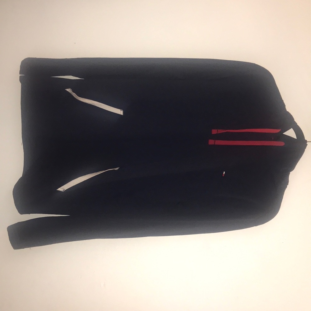 A blue Tommy Hilfiger hoodie with red draw strings